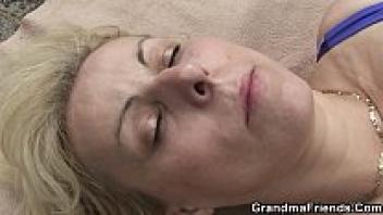 On the beach, a blonde grandmother with a double penetration.