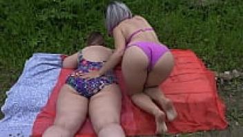 Big-assed, mature lesbians like playing with a rubber dick while lounging in the sun in their swimmers. Outdoor, juicy PAWG shaking doggystyle fetish for amateurs.