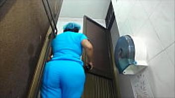 Voyeur: A Latina nurse with a big ass urinates in a public restroom