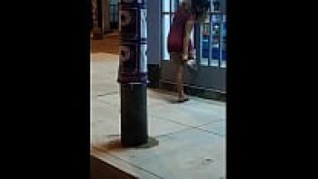 On the street, wearing a red dress upskirt