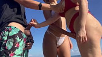 I invite two unidentified girls to assist me as they gaze at my cock while I masturbate on the beach.