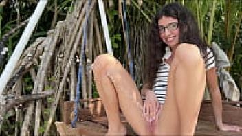 When no one is looking, a beautiful woman wearing glasses urinates forcefully on a swing.