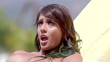 Watch Janice Griffith, a gorgeous and seductive woman, touch her shaved pussy besides the pool.